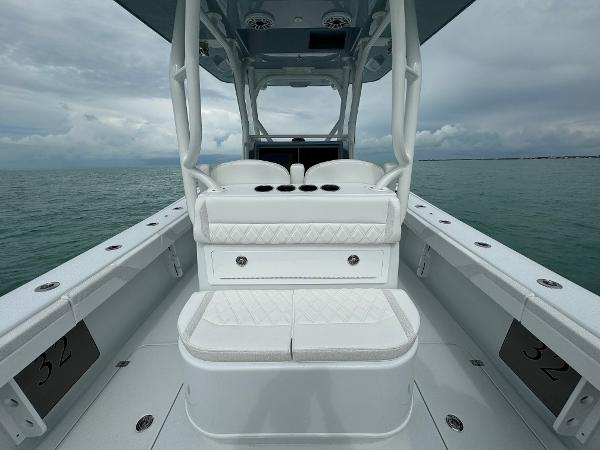 Slide: The Image of 2025 Yellowfin 32 boat interior with white seating on calm water. - 17