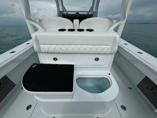 Slide: The Image of 2025 Yellowfin 32 boat interior with seating and storage on open water. - 19