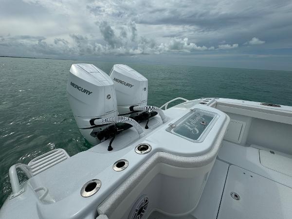 Slide: The Image of 2025 Yellowfin 32 boat with twin Mercury engines on open water. - 22
