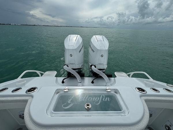 Slide: The Image of 2025 Yellowfin 32 boat with dual Mercury engines on open water. - 23