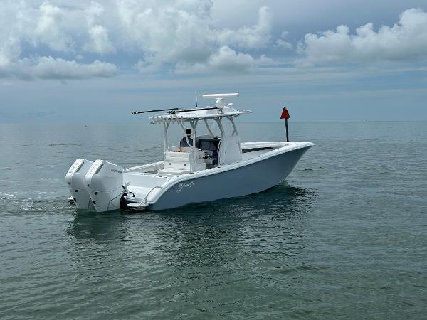 Slide: The Image of 2025 Yellowfin 32 boat cruising on calm ocean waters under cloudy sky. - 3