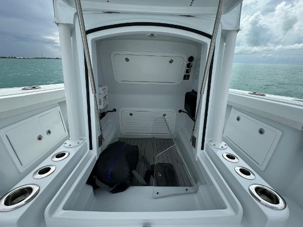 Slide: The Image of 2025 Yellowfin 32 boat interior with storage compartments and rod holders. - 32