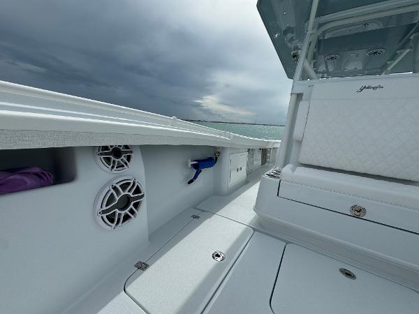 Slide: The Image of 2025 Yellowfin 32 boat interior with speakers and seating under cloudy sky. - 33
