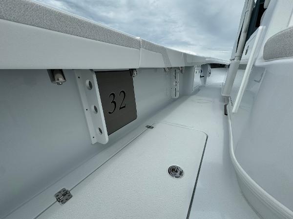 Slide: The Image of 2025 Yellowfin 32 boat interior with sleek white design and storage compartment. - 35