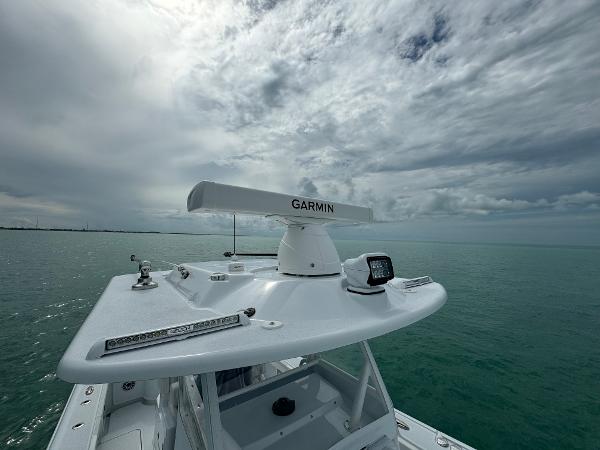 Slide: The Image of 2025 Yellowfin 32 boat with Garmin radar on open sea under cloudy sky. - 39
