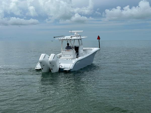 Slide: The Image of 2025 Yellowfin 32 boat cruising on calm ocean waters under cloudy skies. - 5