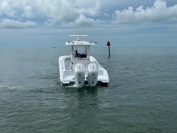 Slide: The Image of 2025 Yellowfin 32 boat on open water under cloudy sky. - 6