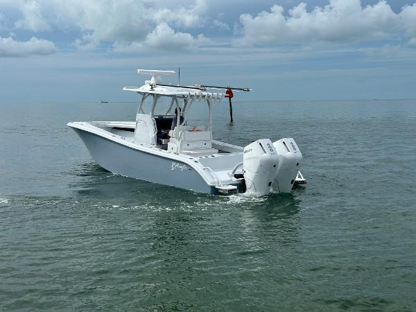 Slide: The Image of 2025 Yellowfin 32 boat on calm water under cloudy sky. - 8