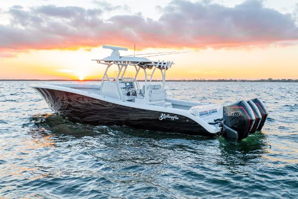 Slide: The Image of 2023 Yellowfin 34 boat on water at sunset with triple engines. - 1