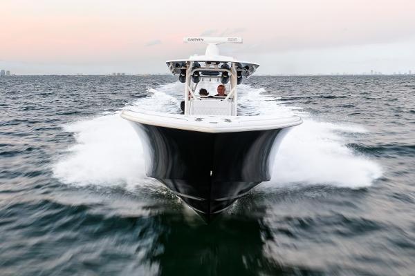 Slide: The Image of 2023 Yellowfin 34 boat cruising on open water at sunset. - 8