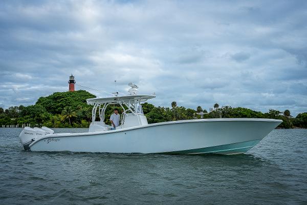 Slide: The Image of 2009 Yellowfin 36 boat cruising near a lighthouse on a cloudy day. - 1