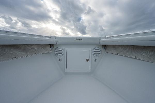 Slide: The Image of 2009 Yellowfin 36 boat interior with storage compartment and speakers under cloudy sky. - 11