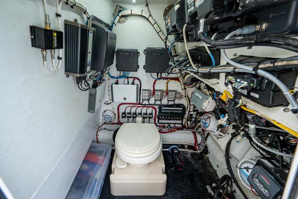 Slide: The Image of 2009 Yellowfin 36 boat electrical room with toilet and wiring. - 20