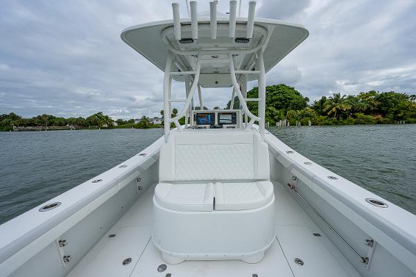 Slide: The Image of 2009 Yellowfin 36 boat with white seating and console on a calm waterway. - 21