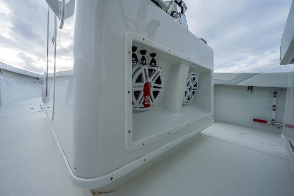 Slide: The Image of 2009 Yellowfin 36 boat interior with built-in speakers and storage compartment. - 25