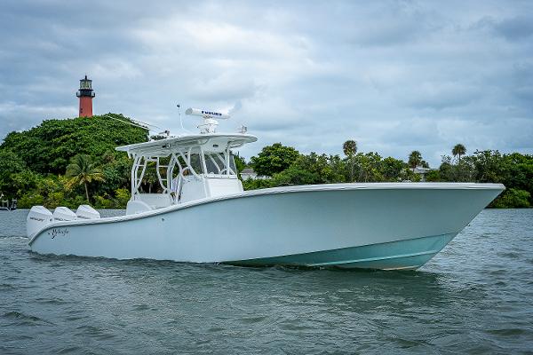 Slide: The Image of 2009 Yellowfin 36 boat cruising near a lighthouse. - 26