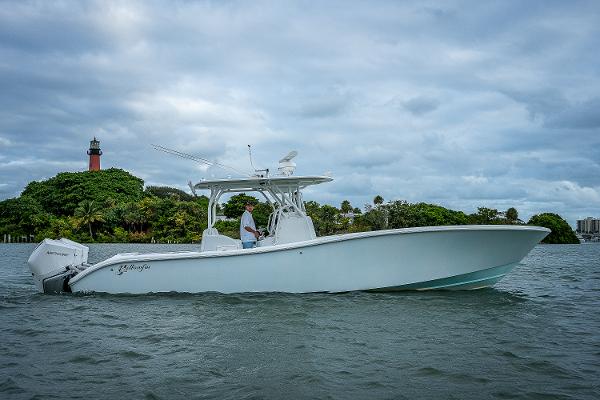 Slide: The Image of 2009 Yellowfin 36 boat cruising on water near a lighthouse. - 27