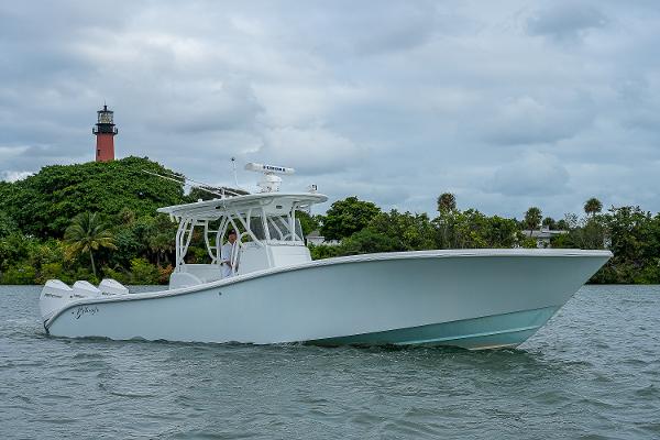 Slide: The Image of 2009 Yellowfin 36 boat cruising near a lighthouse on a cloudy day. - 29