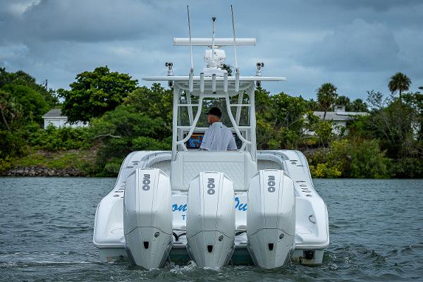 Slide: The Image of 2009 Yellowfin 36 boat with triple outboard engines on the water. - 3