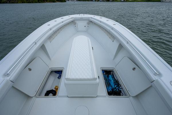 Slide: The Image of 2009 Yellowfin 36 boat bow with storage compartments open on the water. - 7