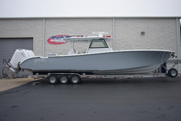 Slide: The Image of 2024 Yellowfin 42 boat on a trailer outside a warehouse. - 1