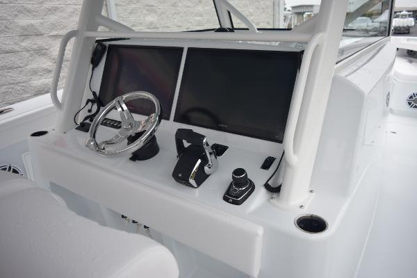 Slide: The Image of 2024 Yellowfin 42 boat dashboard with dual screens and steering wheel. - 16
