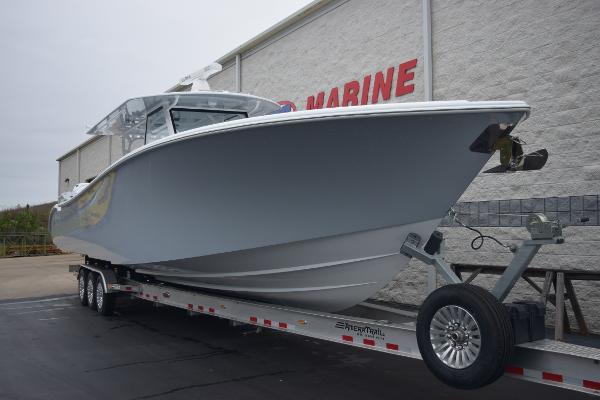 Slide: The Image of 2024 Yellowfin 42 boat on a trailer outside a marine dealership. - 2