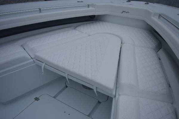 Slide: The Image of 2024 Yellowfin 42 boat with white cushioned seating area. - 23
