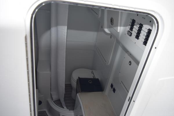 Slide: The Image of 2024 Yellowfin 42 boat interior bathroom with toilet and control panel. - 25