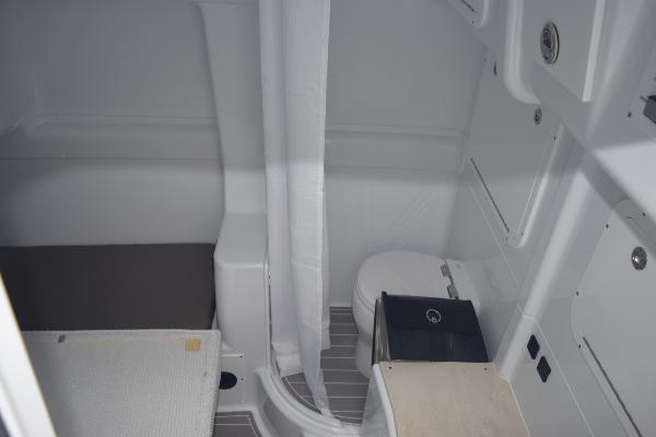 Slide: The Image of 2024 Yellowfin 42 boat interior bathroom with toilet and shower. - 26