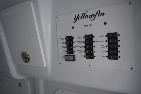 Slide: The Image of Yellowfin 42 2024 boat control panel with 12V DC switches. - 28