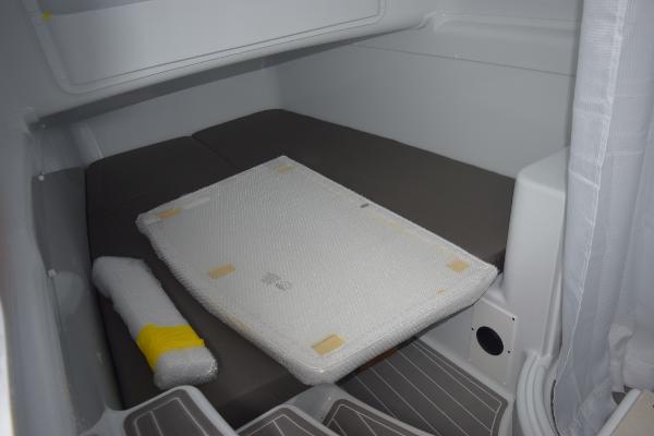 Slide: The Image of 2024 Yellowfin 42 interior cabin with cushioned seating and packaging materials. - 29