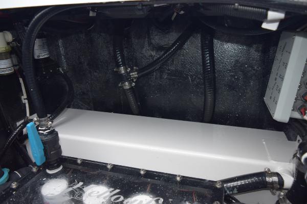 Slide: The Image of Engine compartment of a 2024 Yellowfin 42 boat with visible hoses and components. - 42