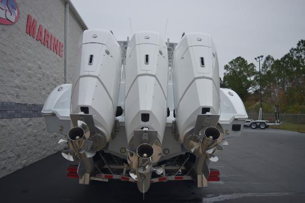 Slide: The Image of 2024 Yellowfin 42 boat with triple outboard engines at a marine dealership. - 5