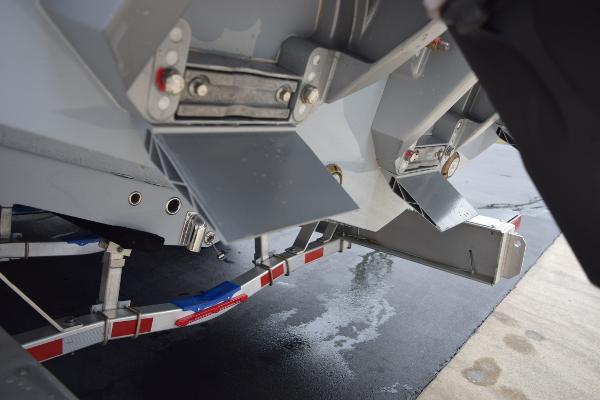 Slide: The Image of Close-up of the 2024 Yellowfin 42 boat's trim tabs and trailer. - 9