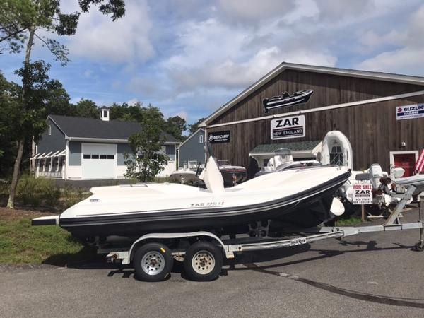 Slide: The Image of 2024 Zar Formenti 59 SL boat on a trailer outside a dealership. - 3