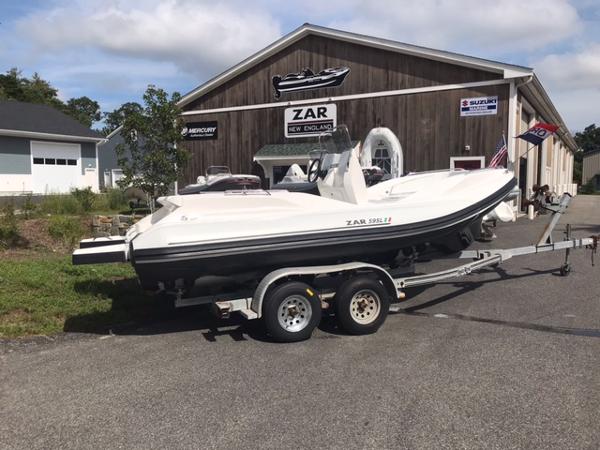 Slide: The Image of 2024 Zar Formenti 59 SL boat on a trailer outside a dealership. - 5