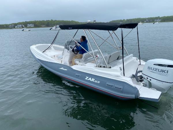 Slide: The Image of 2023 Zar Formenti Zar 65 boat with Suzuki outboard motor on a lake. - 0