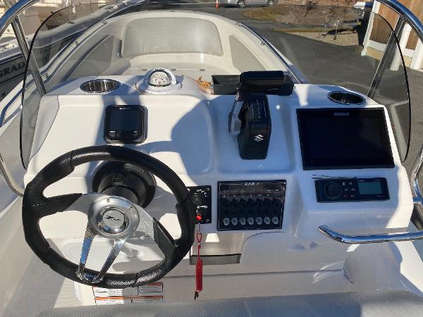 Slide: The Image of 2023 Zar Formenti Zar 65 boat dashboard with steering wheel and navigation controls. - 5