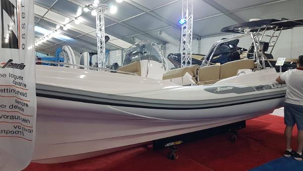 Slide: The Image of 2023 Zar Formenti Zar 65 boat displayed at an indoor boat show. - 7