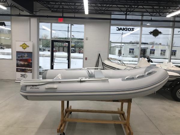 Slide: The Image of 2023 Zodiac Cadet 300 RIB ALU PVC inflatable boat displayed indoors. - 0