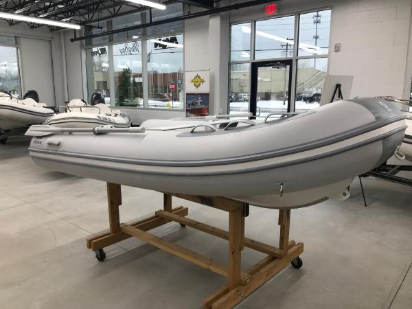 Slide: The Image of 2023 Zodiac Cadet 300 RIB ALU PVC boat displayed in showroom. - 1