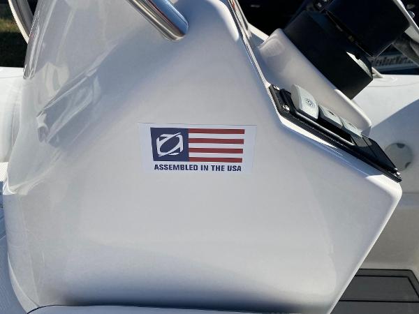 Slide: The Image of Zodiac Yachtline 360 (2024) with Assembled in the USA sticker on white console. - 3