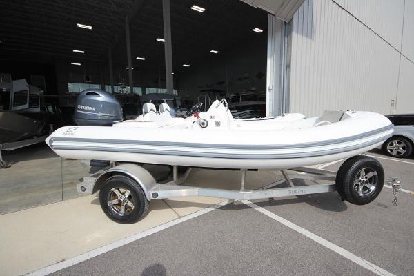Slide: The Image of 2023 Zodiac Yachtline 490 Deluxe NEO 90hp on trailer outside showroom. - 0