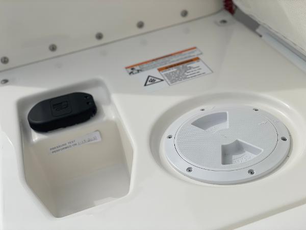 Slide: The Image of 2023 Zodiac Yachtline 490 Deluxe NEO 90hp control panel and storage compartment. - 16