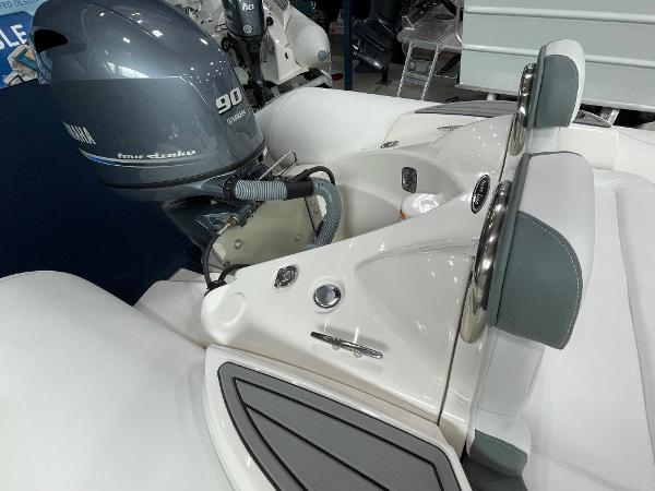 Slide: The Image of 2023 Zodiac Yachtline 490 Deluxe NEO 90hp boat engine and seating area. - 19