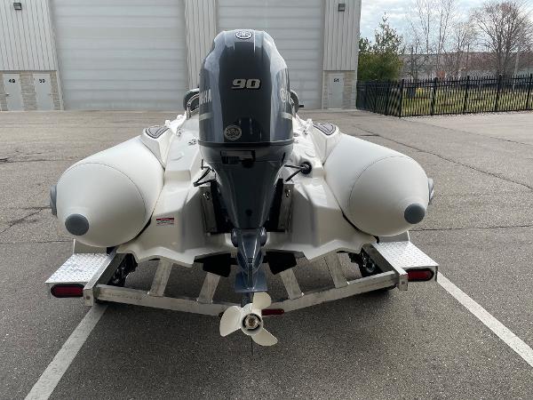 Slide: The Image of 2023 Zodiac Yachtline 490 Deluxe NEO 90hp on trailer, rear view. - 6