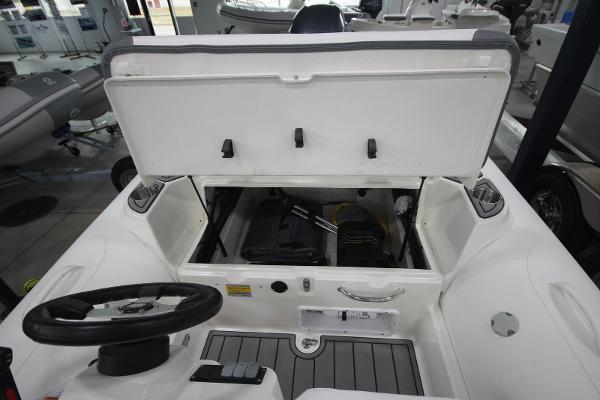 Slide: The Image of 2023 Zodiac Yachtline 490 Deluxe NEO 90hp boat interior with open storage compartment. - 8