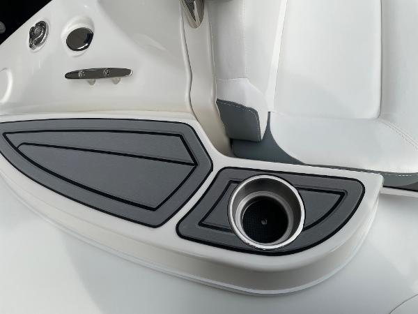 Slide: The Image of Close-up of 2023 Zodiac Yachtline 490 Deluxe NEO 90hp boat interior, featuring cup holder and seating. - 9